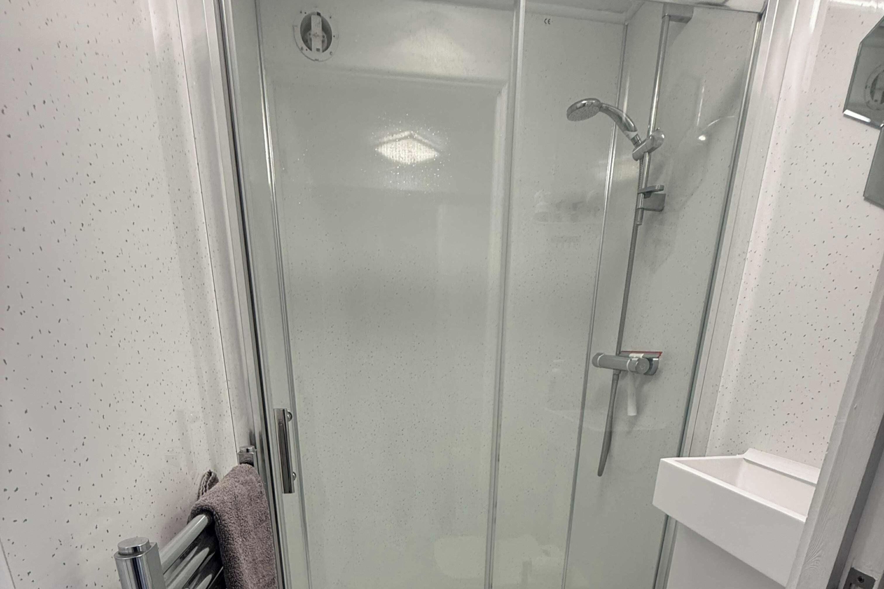 Shower, hair dryer, towels, shampoo