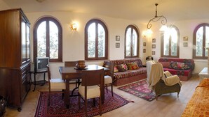 Una sala de estar amplia con comedor, ventanas grandes y chimenea.