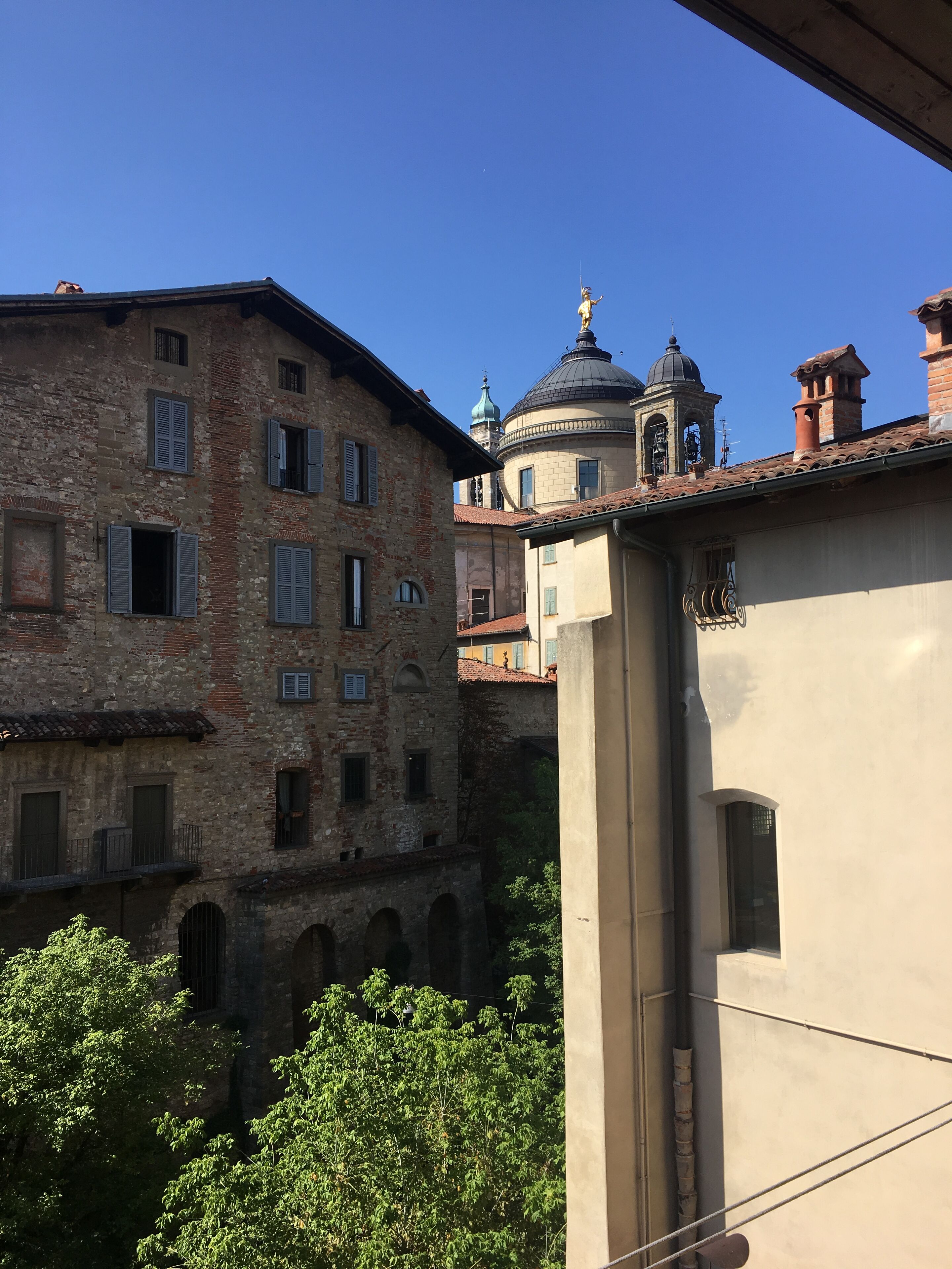 A historic building with a bell tower and arched windows.