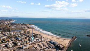 An aerial view of a coastal town with a beach, residential area, and a lighthouse. - Santa Cruz Harbor Vacation (Santa Cruz)