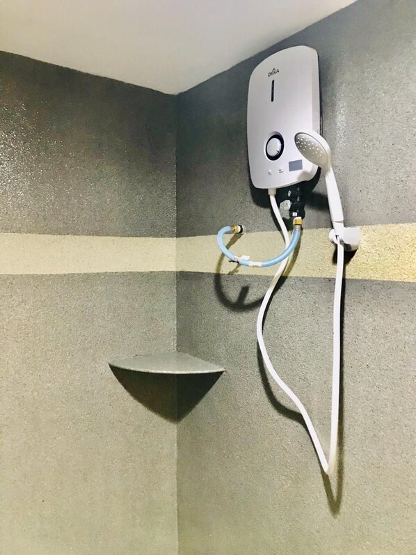 A shower with a handheld showerhead and a wall-mounted control panel.