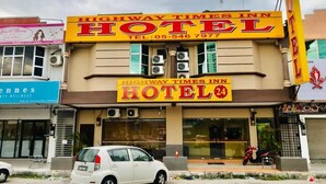 A building with a sign for "Highway Times Inn Hotel" and a smaller sign for "Highway Times Inn Beauty Wellness." - Highway Times Inn (Ipoh)