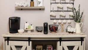 A kitchen counter with coffee-making equipment, a coffee bar sign, and a wall-mounted mug rack. - FREE Early Check-In When Available! (Kissimmee)