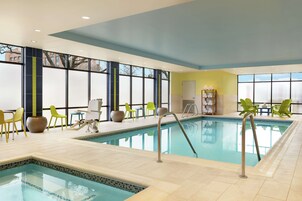 Una piscina techada, sillones reclinables de piscina