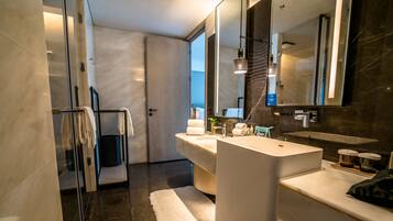 King One Bedroom Family Suite | Bathroom | Designer toiletries, hair dryer, bathrobes, slippers