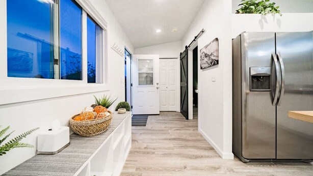 A modern kitchen with a stainless steel refrigerator, a wooden countertop, and a window with a view of the outside. - Coffee Lover`s Loft! Walk to Lake & brews. A/C (Estes Park)