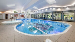 An indoor swimming pool with a tiled floor, a hot tub, and a glass wall with a view of the outdoors. - Modern 1-Bed Apartment | Near Lancaster | Sleeps 4 (Lancaster)