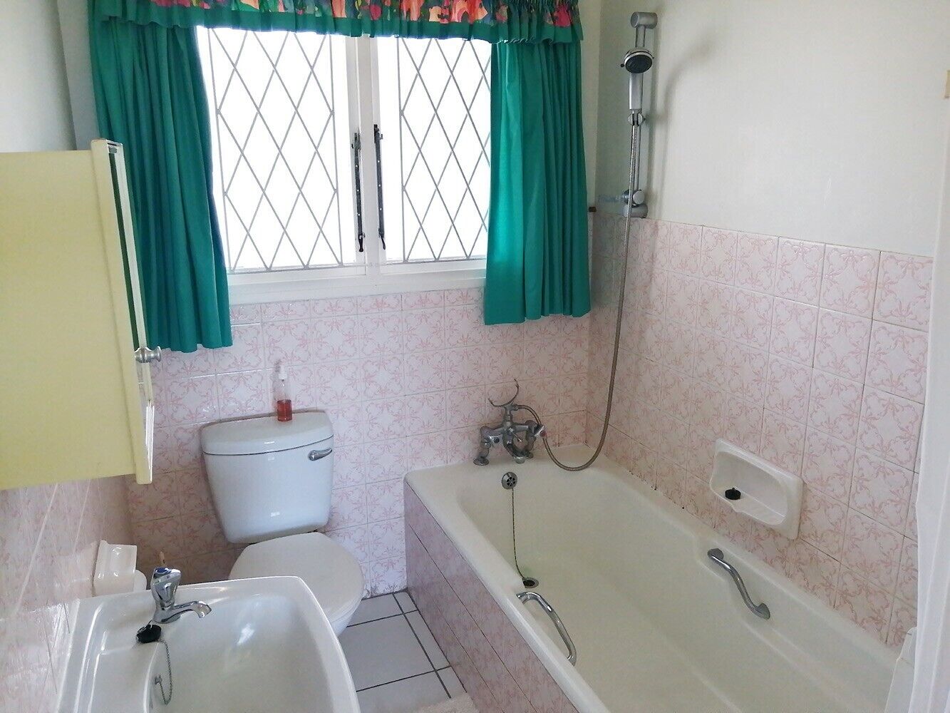 A bathroom with a toilet, sink, bathtub, and shower.