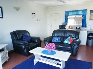 Apartment, 1 Bedroom | Living area | 32-inch flat-screen TV with cable channels, TV - Southern Comfort - Periwinkle (Margate)