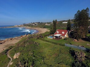 A coastal property with a swimming pool, a fenced yard, and a view of the ocean. - Whaleback Cottage (Margate)