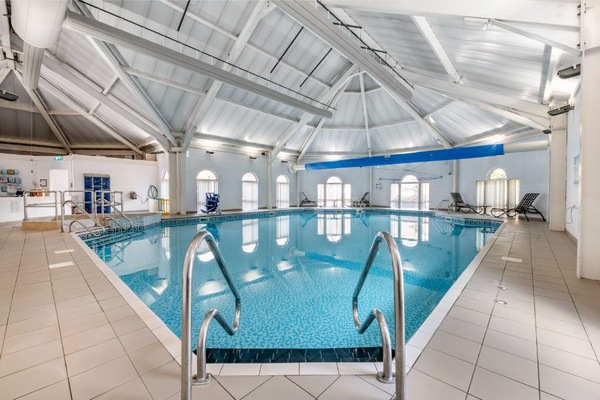 Another view of the indoor pool, showcasing the expansive space and multiple lanes.