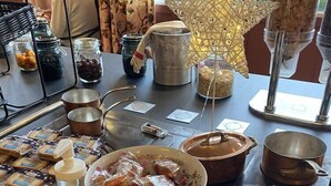 A kitchen counter with various food items and cooking utensils. - Kyriad Nuits-saint-georges (Nuits-Saint-Georges)