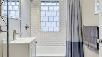 Bathtub, hair dryer, towels, soap