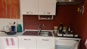 A compact kitchen with a sink, stove, and storage cabinets. - At 8km from the sea two-story apartment in villa (Cisano Sul Neva)