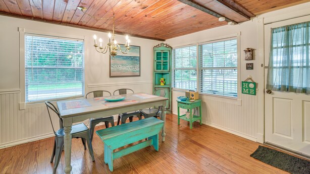 A dining area with a wooden ceiling, a table with chairs, a bench, and a green cabinet. - 2 Mi to Marina: Inglis Retreat w/ Boat Parking (Inglis)