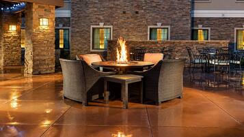 Outdoor fire pit surrounded by comfortable chairs and seating.