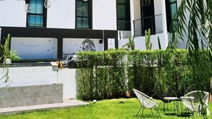 A modern building with large windows and a flat roof. There are outdoor seating areas with chairs and tables. - Blu Monkey Hub & Hotel Ranong (Ranong)