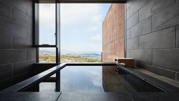 Enjoy a city view from the large window, with a bench and minimalist decor.