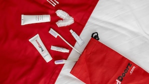 A neatly arranged set of personal care items on a red and white fabric background.