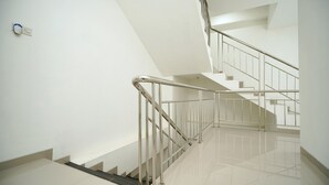 A modern staircase with metal railings and a clean, white interior.