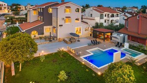 A modern two-story house with a swimming pool, outdoor seating, and a well-maintained garden. - Villa Zorica in Poreč with 7 Bedrooms, Pool, Fireplace (Poreč)