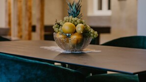 A dining table with a glass bowl of fruit in the center. - Mix of modern and antique , New visage villa Antico (Seget Donji)