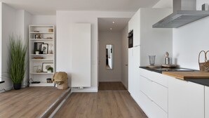 A modern kitchen with white cabinetry, a wooden countertop, and a built-in stove. - Luxurious Penthouse, rooftop terrace, spectacular view! (Antwerpen)