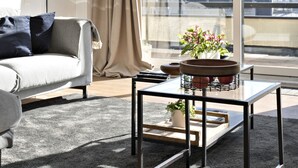 A modern living room with a sofa, a coffee table, and a view of the city through large windows. - Luxurious Penthouse, rooftop terrace, spectacular view! (Antwerpen)