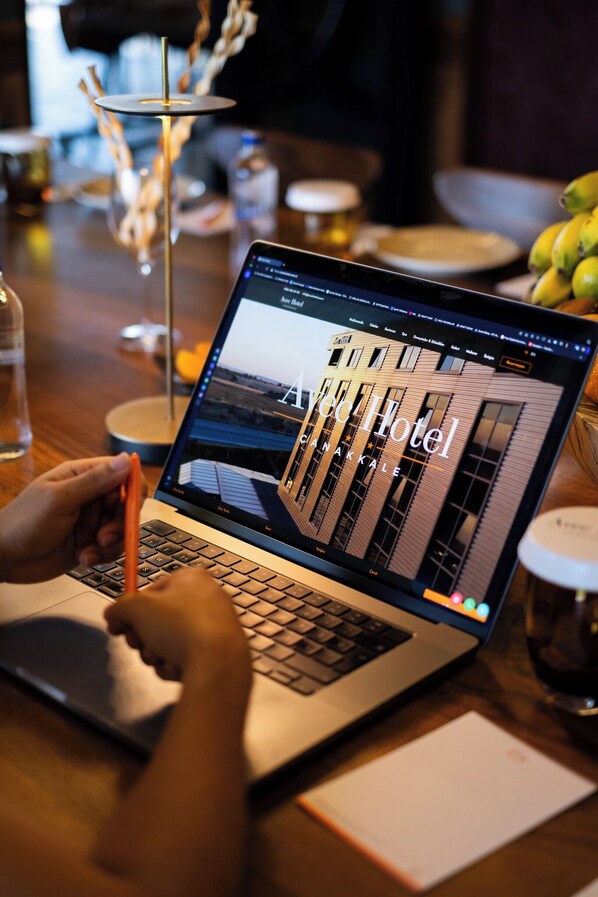 A laptop displaying a hotel website with a view of a building. - Avec Hotel (Çanakkale)