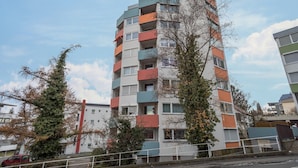 A multi-story residential building with balconies, a visible staircase, and a clear sky. - Apartment “Förster” with Balcony and Wi-Fi (Überlingen)
