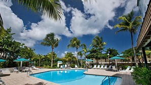 A swimming pool with lounge chairs and palm trees. - Walk To The Beach From This Beautifull New Studio With Everything You Need (St. Thomas)