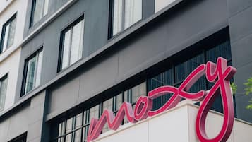 A multi-story building with a prominent red sign that reads "Mox".