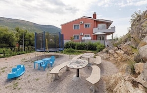 Relax in the resort's outdoor recreational area, featuring a trampoline, play structure, and seating area.