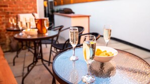 A restaurant setting with round tables, chairs, and a bar area. - The Station Lodge, Filey. Sleeps 12 (Filey)