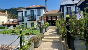 A residential area with modern houses, a paved pathway, and potted plants. - On Oda Oludeniz (Fethiye)