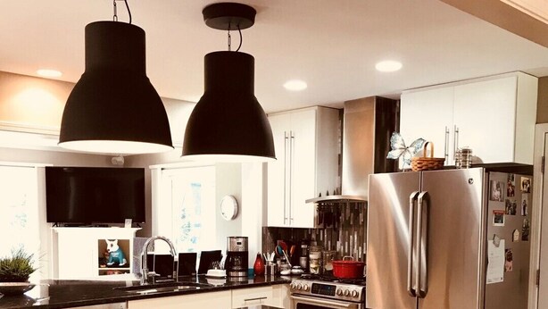 A modern kitchen with a central island, stainless steel appliances, and black bar stools. - HOT TUB Columbus Indiana  (Columbus)