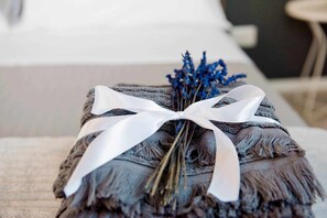 A bed with a white ribbon and dried lavender.