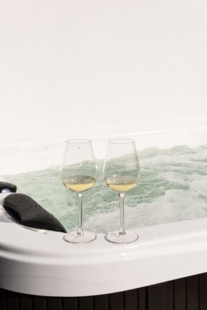 Two glasses of white wine in a hot tub with a view of the water. - NorteSoul Mouzinho (Porto)
