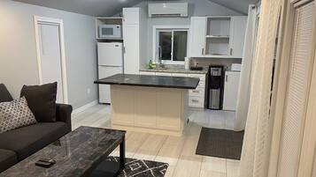 Fridge, microwave, coffee/tea maker, cookware/dishes/utensils