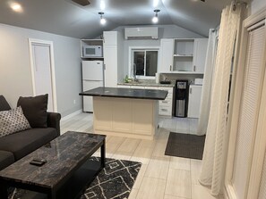 Fridge, microwave, coffee/tea maker, cookware/dishes/utensils