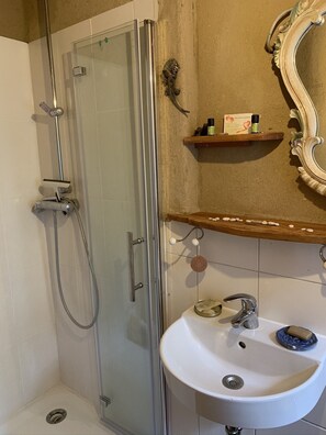 Shower, towels, soap, toilet paper