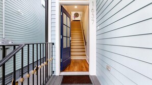 A staircase leading to a door with the number 1037. - 15% OFF Monthly | 10% OFF Weekly- Chic Urban Retreat w Pool Steps to St. Charles Ave and (New Orleans)