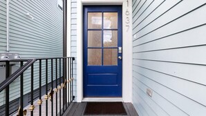 A blue door with a window, a mailbox, and a number 1637 on the wall. - 15% OFF Monthly | 10% OFF Weekly- Chic Urban Retreat w Pool Steps to St. Charles Ave and (New Orleans)