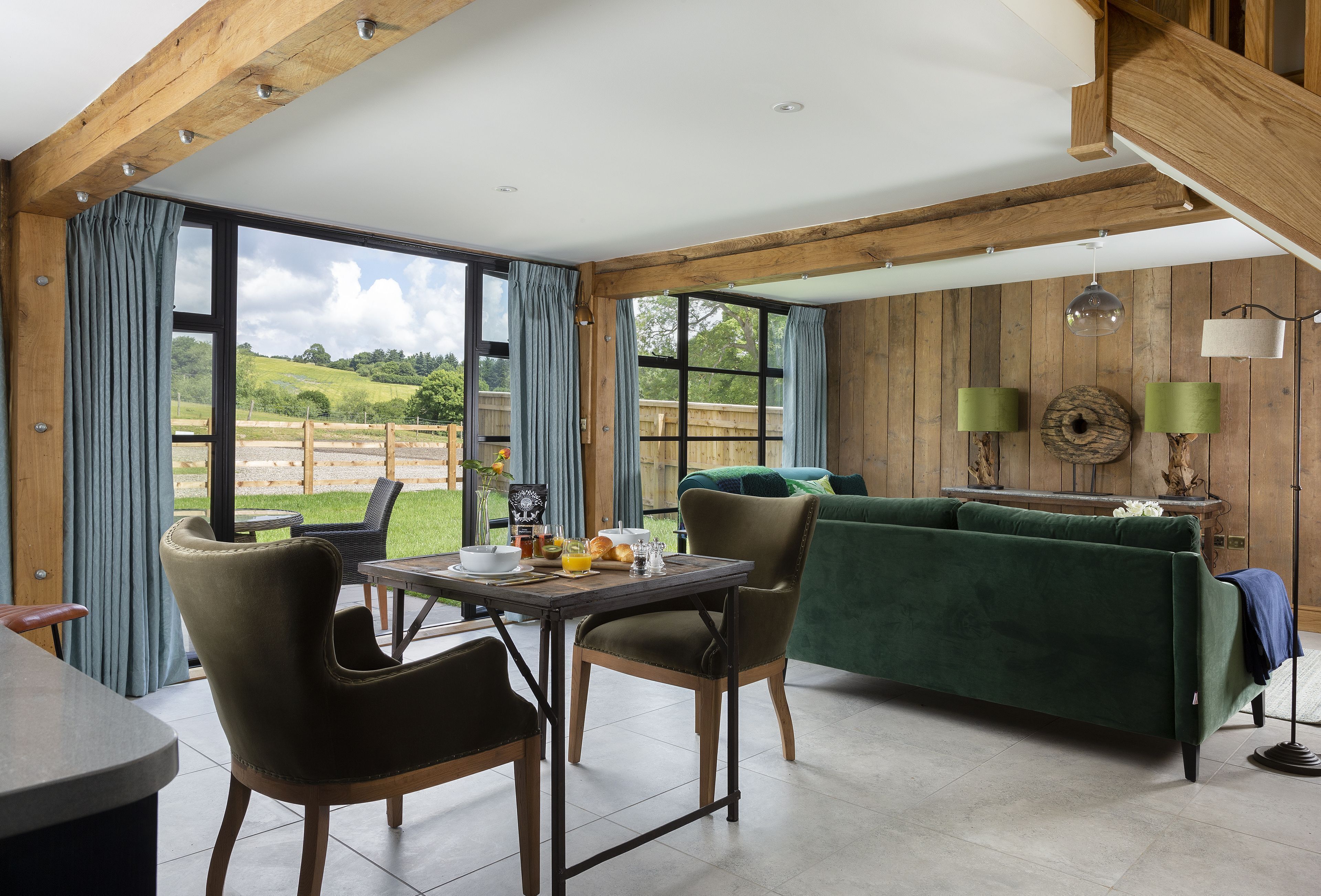 A dining area with a table, chairs, and a view of the outdoors.