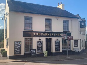 A building with a sign reading 'The Parkers Arms' and multiple advertisements for meals and events. - The Parkers Arms (Paignton)