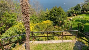 A scenic view of a mountainous landscape with a lake, lush greenery, and a wooden staircase leading to a viewing platform. - Wonderful private villa for 2 guests with TV, patio and pets allowed (Belmonte)