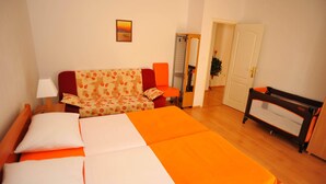 A hotel room with a bed, a chair, a desk, and a door. - Villa Anni - Two-Bedroom Apartment with Terrace (Sutivan)