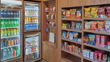 A snack and beverage display with various products including chips, cookies, and bottled drinks.