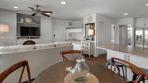 A modern kitchen with white cabinetry, a built-in oven, and a stainless steel refrigerator. - Sleeps 6 @ Beachwood Villas 2 Pools, Mins to Beach + Free Attraction Tickets! (Santa Rosa Beach)