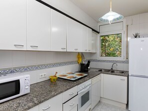Microwave, oven, dishwasher, dining tables